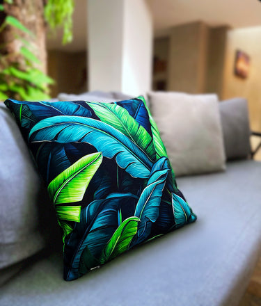 Decorative pillow with tropical leaf pattern on a couch